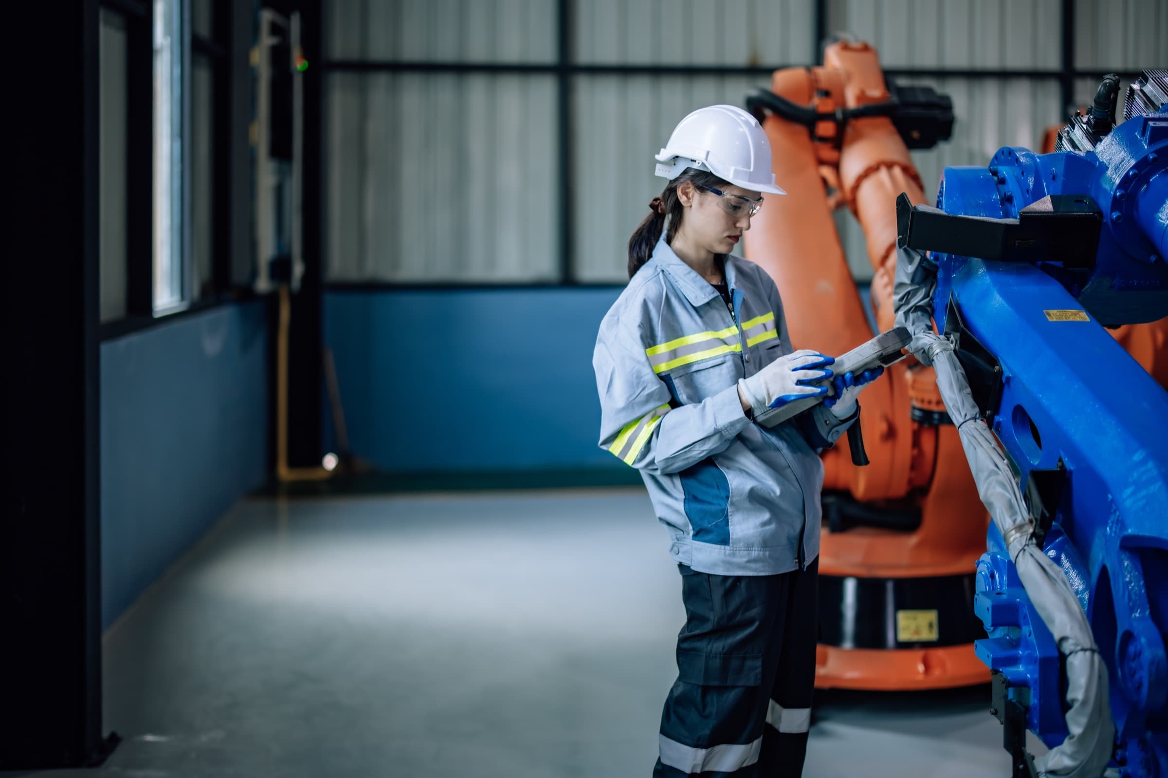 Engineer working with a robotic arm